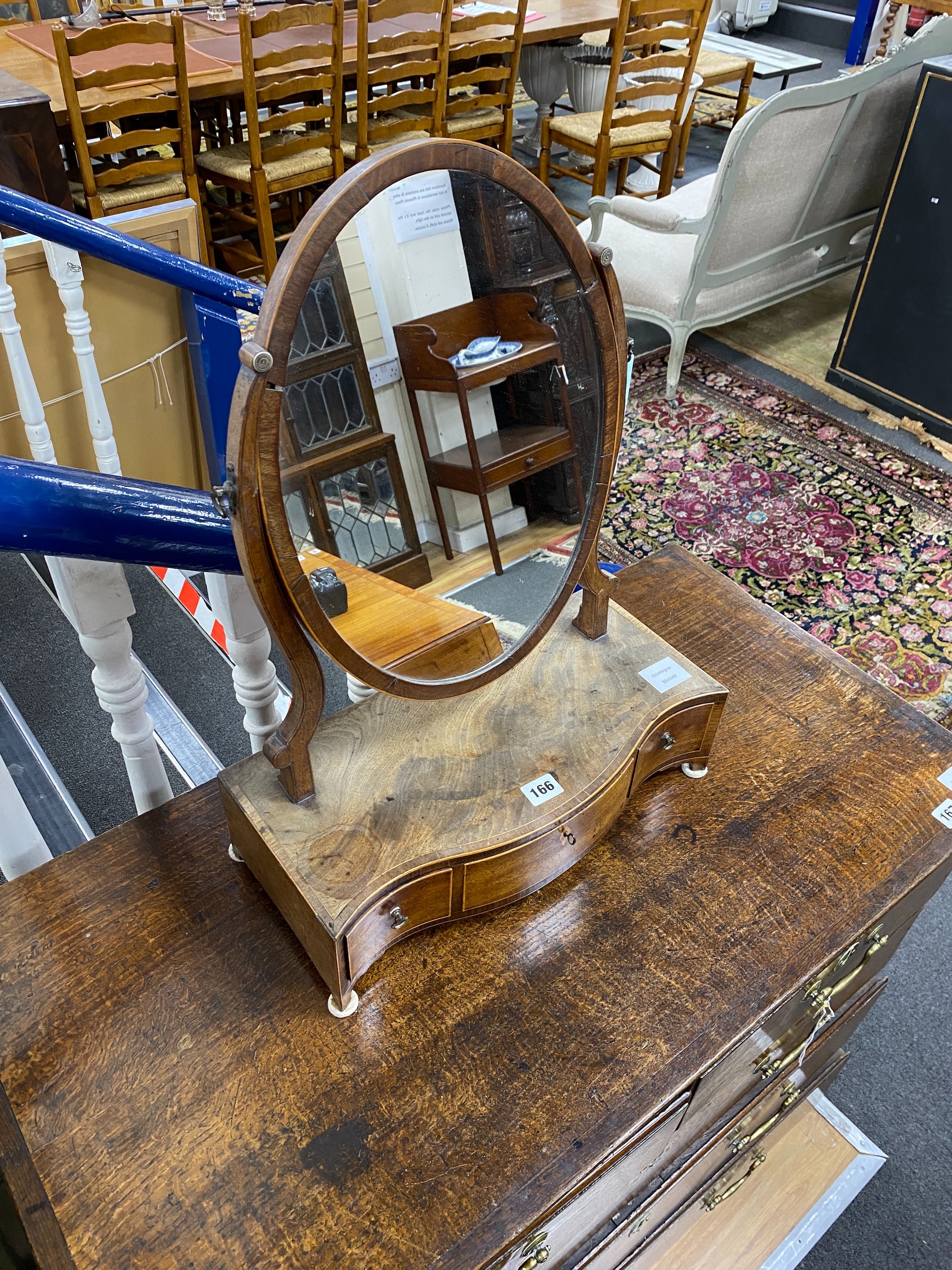 A George III tulipwood banded mahogany serpentine fronted toilet mirror, width 43cm, depth 21cm, height 58cm